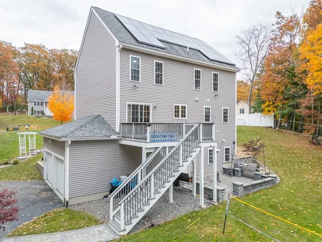 a view of a house with pool and sitting area