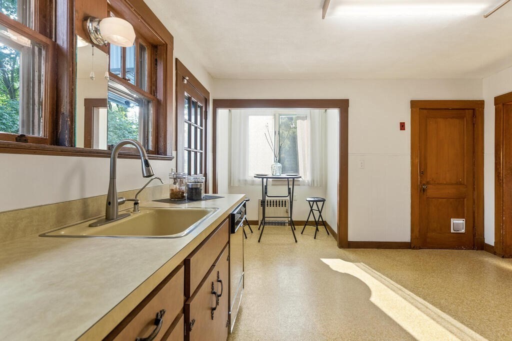 35 Brook Street Wakefield, MA 01880 - Photo 12 of 33 a kitchen with a sink a table and chairs