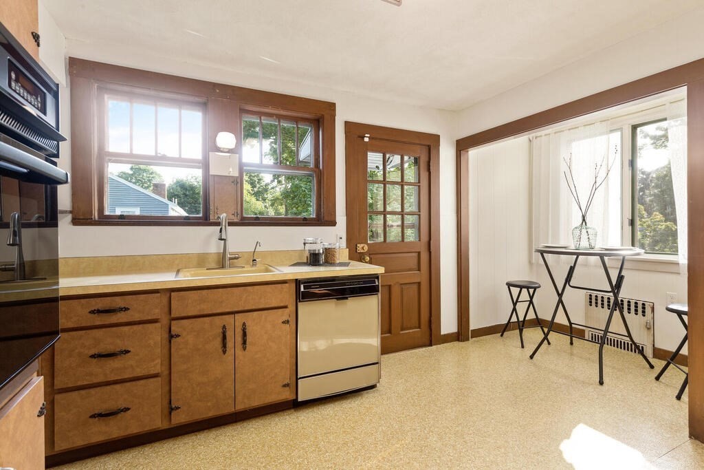 35 Brook Street Wakefield, MA 01880 - Photo 15 of 33 a kitchen with a sink and wooden cabinets