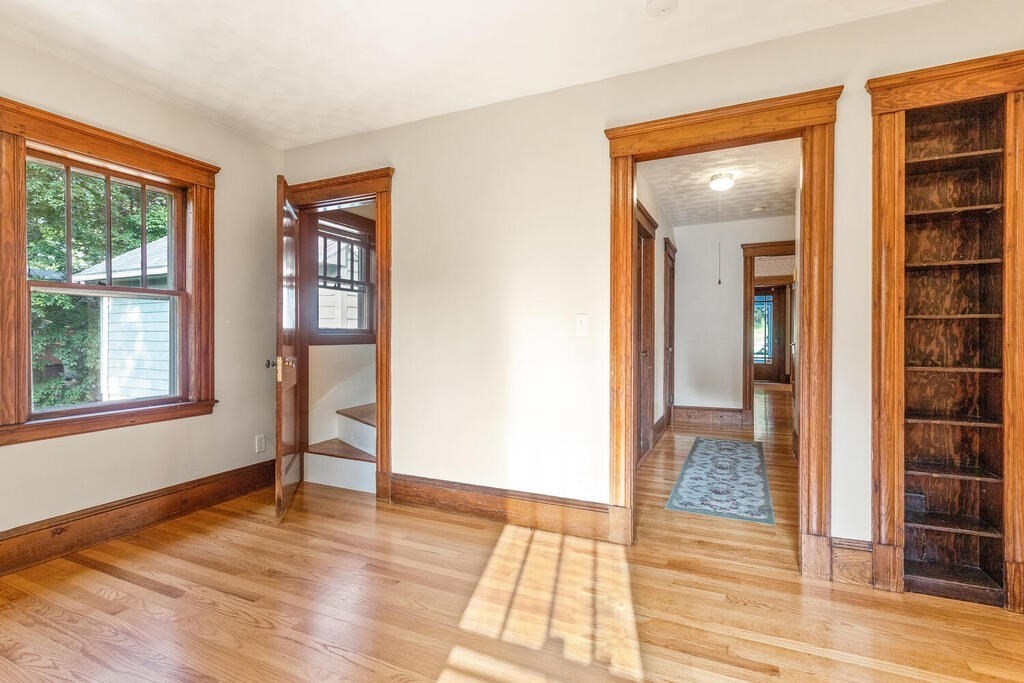 35 Brook Street Wakefield, MA 01880 - Photo 19 of 33 an empty room with wooden floor and windows