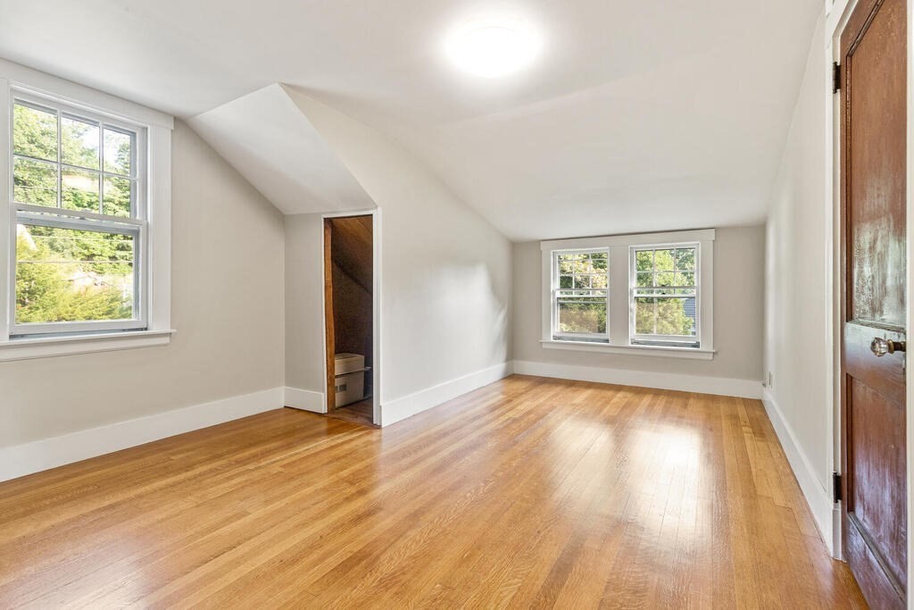 35 Brook Street Wakefield, MA 01880 - Photo 20 of 33 a view of an empty room with wooden floor and a window