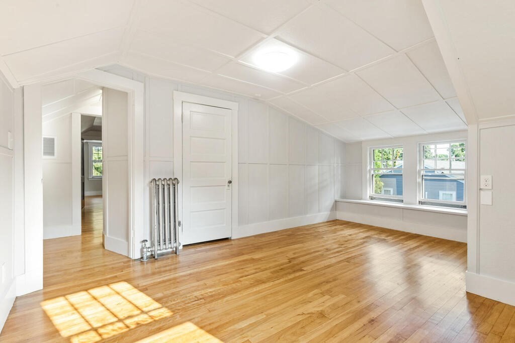 35 Brook Street Wakefield, MA 01880 - Photo 22 of 33 an empty room with wooden floor and windows