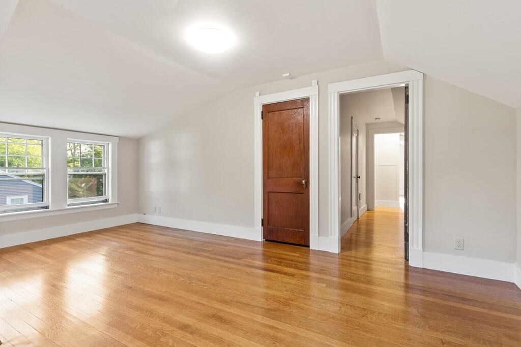 35 Brook Street Wakefield, MA 01880 - Photo 23 of 33 an empty room with wooden floor and windows