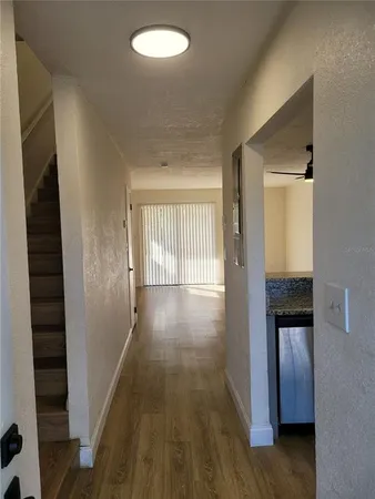 a view of hallway with wooden floor