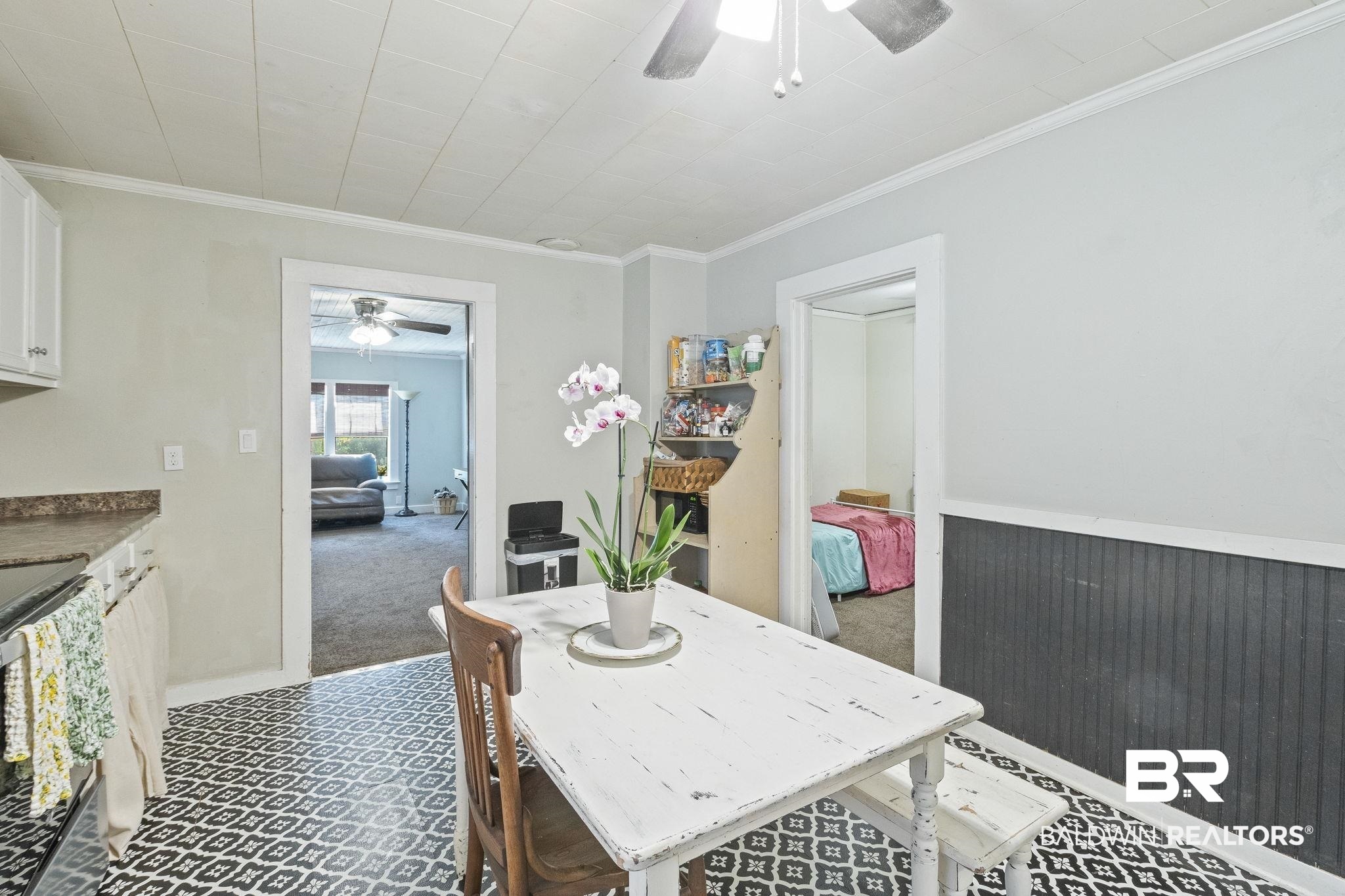 707 North Cedar Street Foley, AL 36535 - Photo 15 of 69 Carpeted dining space with ornamental molding and ceiling fan