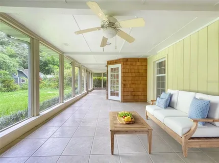 a living room with furniture and a floor to ceiling window