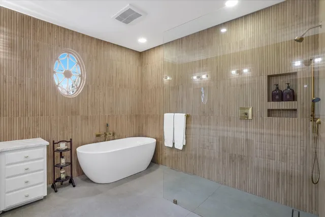 a spacious bathroom with a bathtub and shower