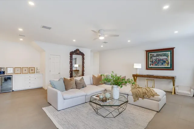 a living room with furniture and white walls