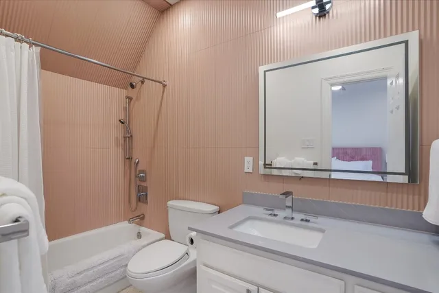 a bathroom with a sink vanity mirror and toilet