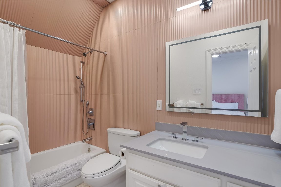 3705 Gilbert Street, Unit B Austin, TX 78703 - Photo 22 of 35 a bathroom with a sink vanity mirror and toilet
