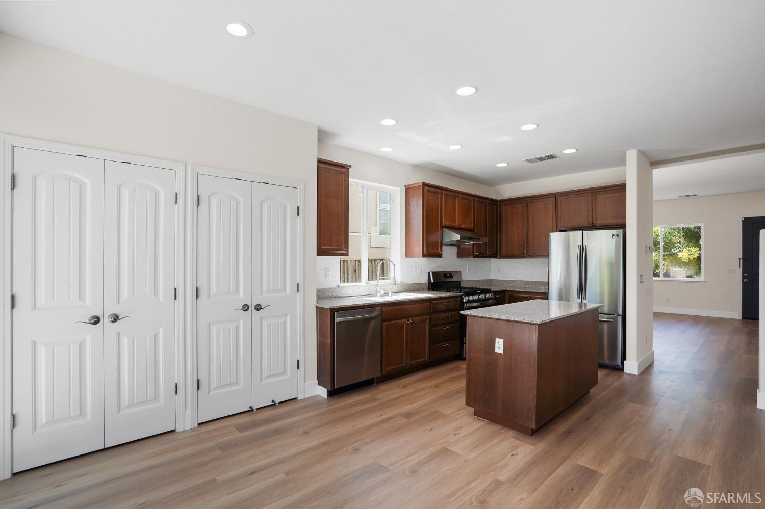 5290 Sungrove Way Antioch, CA 94531 - Photo 11 of 47 a kitchen with stainless steel appliances granite countertop a refrigerator a stove and a wooden floors