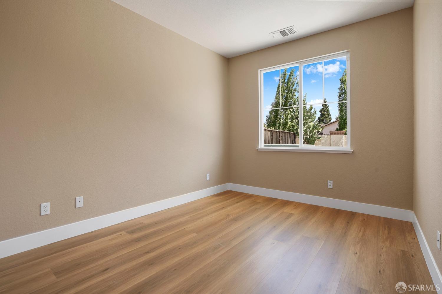 5290 Sungrove Way Antioch, CA 94531 - Photo 18 of 47 a view of an empty room with wooden floor and a window