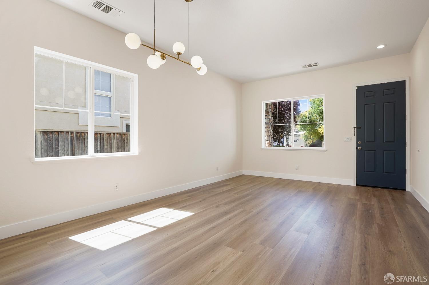 5290 Sungrove Way Antioch, CA 94531 - Photo 7 of 47 a view of an empty room with wooden floor and a window