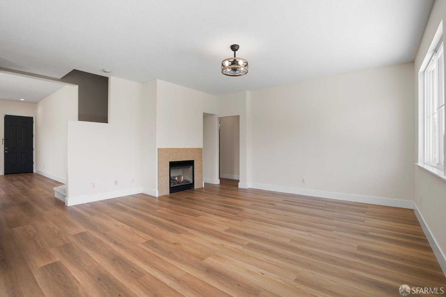 5290 Sungrove Way Antioch, CA 94531 - Photo 10 of 47 a view of an empty room with wooden floor fireplace and a window
