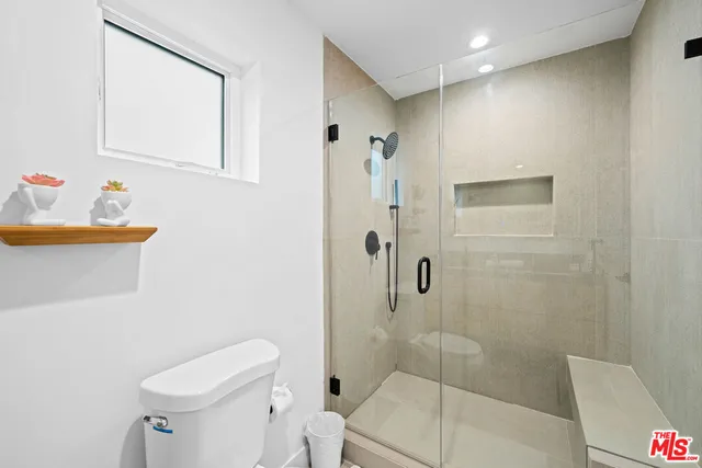 a bathroom with a toilet sink and shower