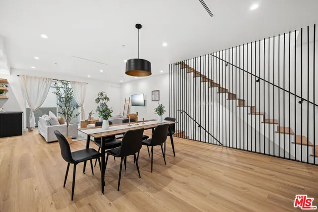 a dining room with furniture and wooden floor