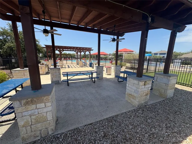 a view of a small house with potted plants