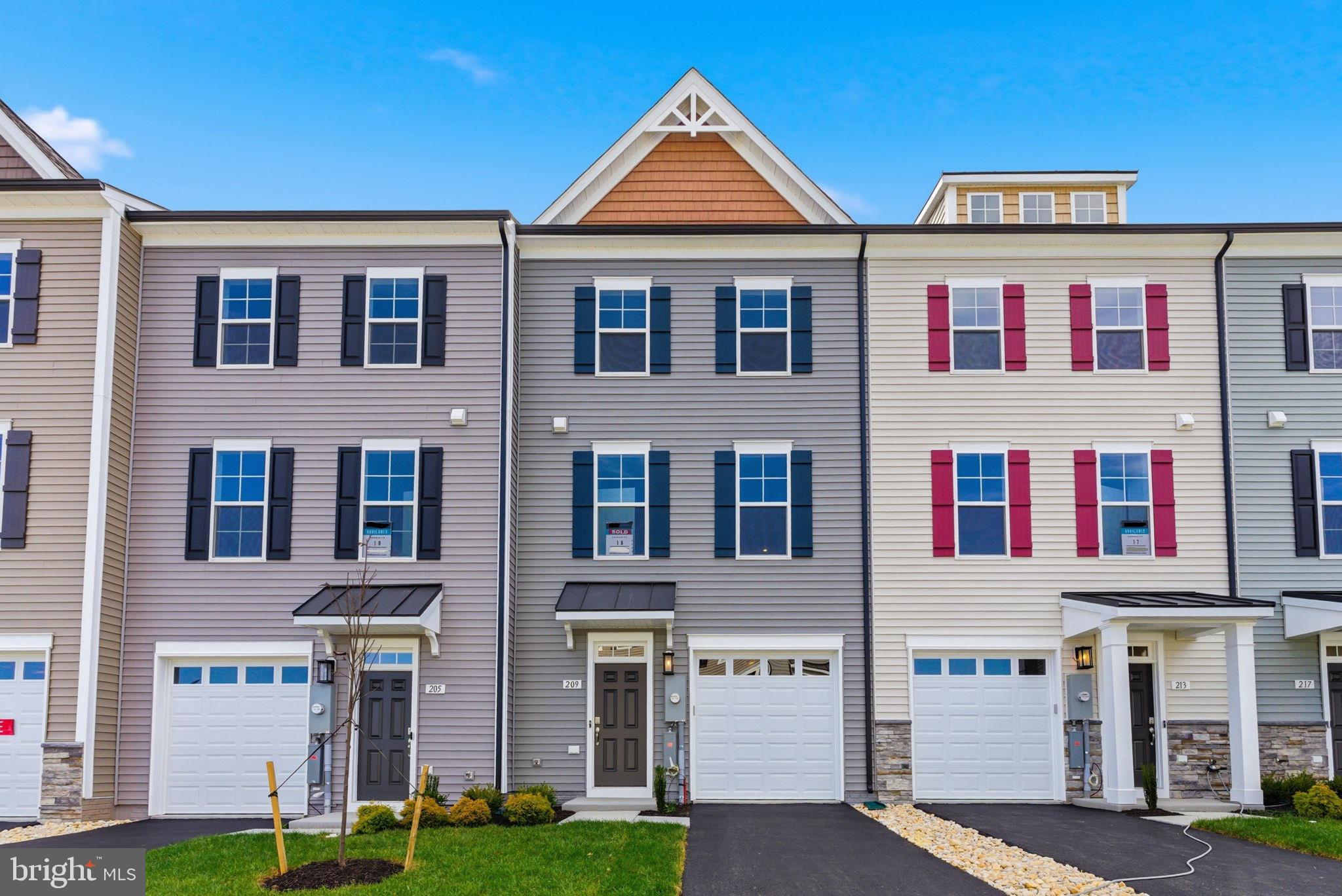 a front view of residential houses with yard