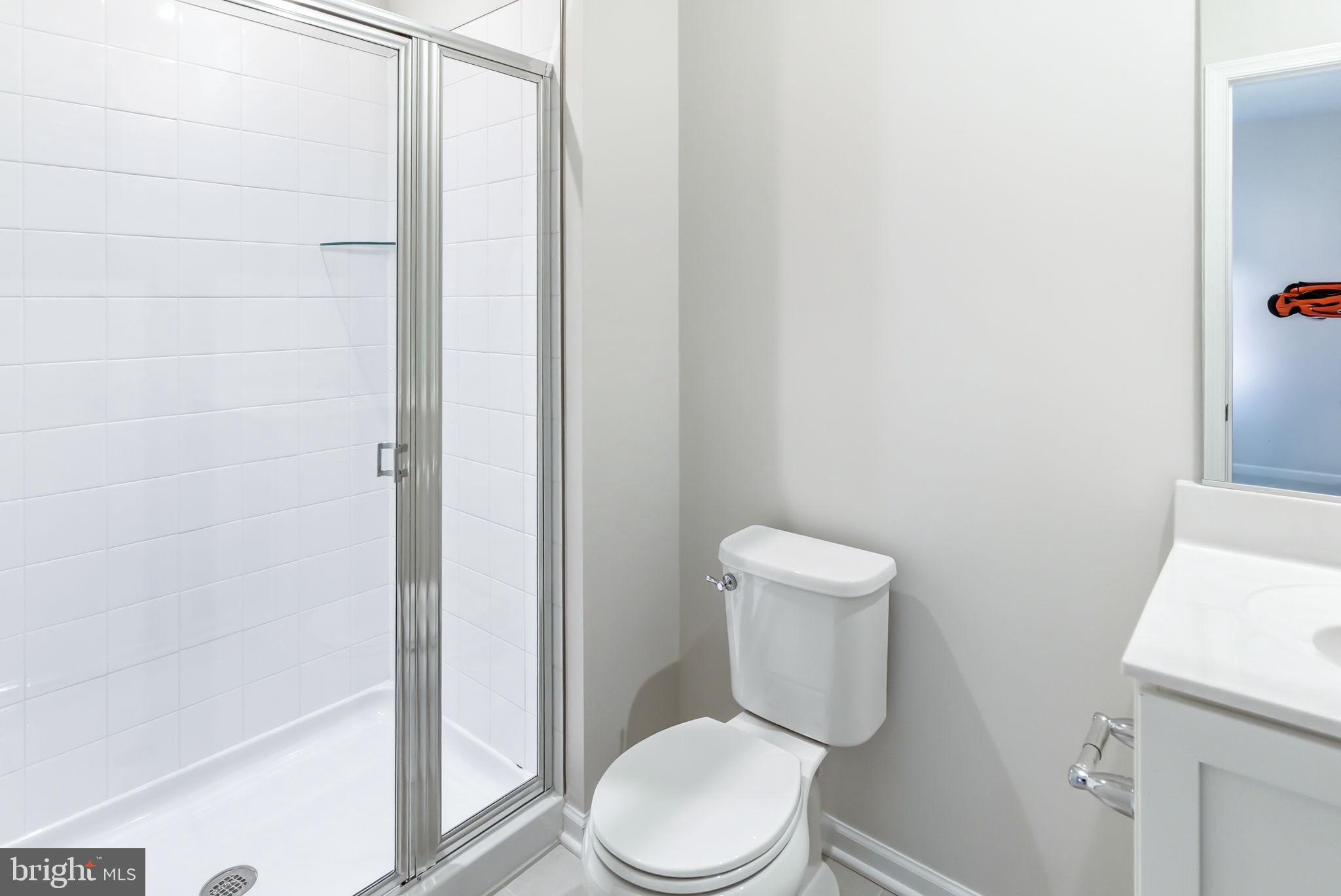 209 Monteith Drive Winchester, VA 22601 - Photo 15 of 29 a white toilet sitting next to a bathroom sink