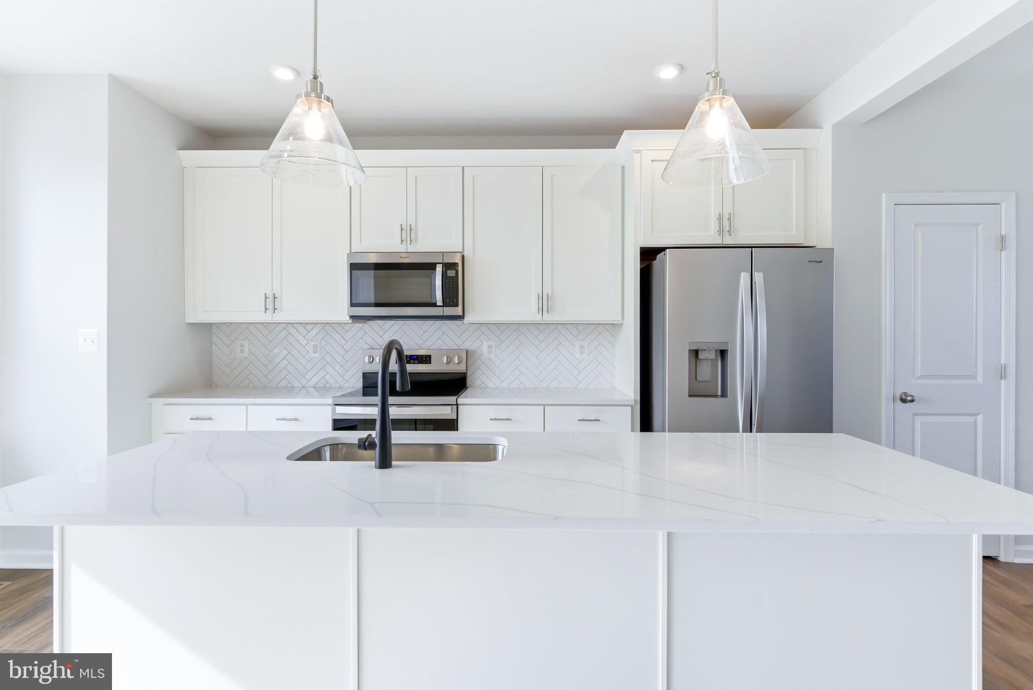 209 Monteith Drive Winchester, VA 22601 - Photo 3 of 29 a kitchen with kitchen island a white cabinets and stainless steel appliances