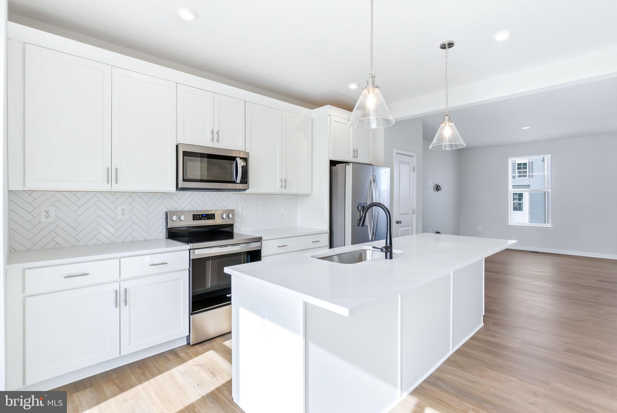 209 Monteith Drive Winchester, VA 22601 - Photo 4 of 29 a kitchen with kitchen island a sink stainless steel appliances and cabinets