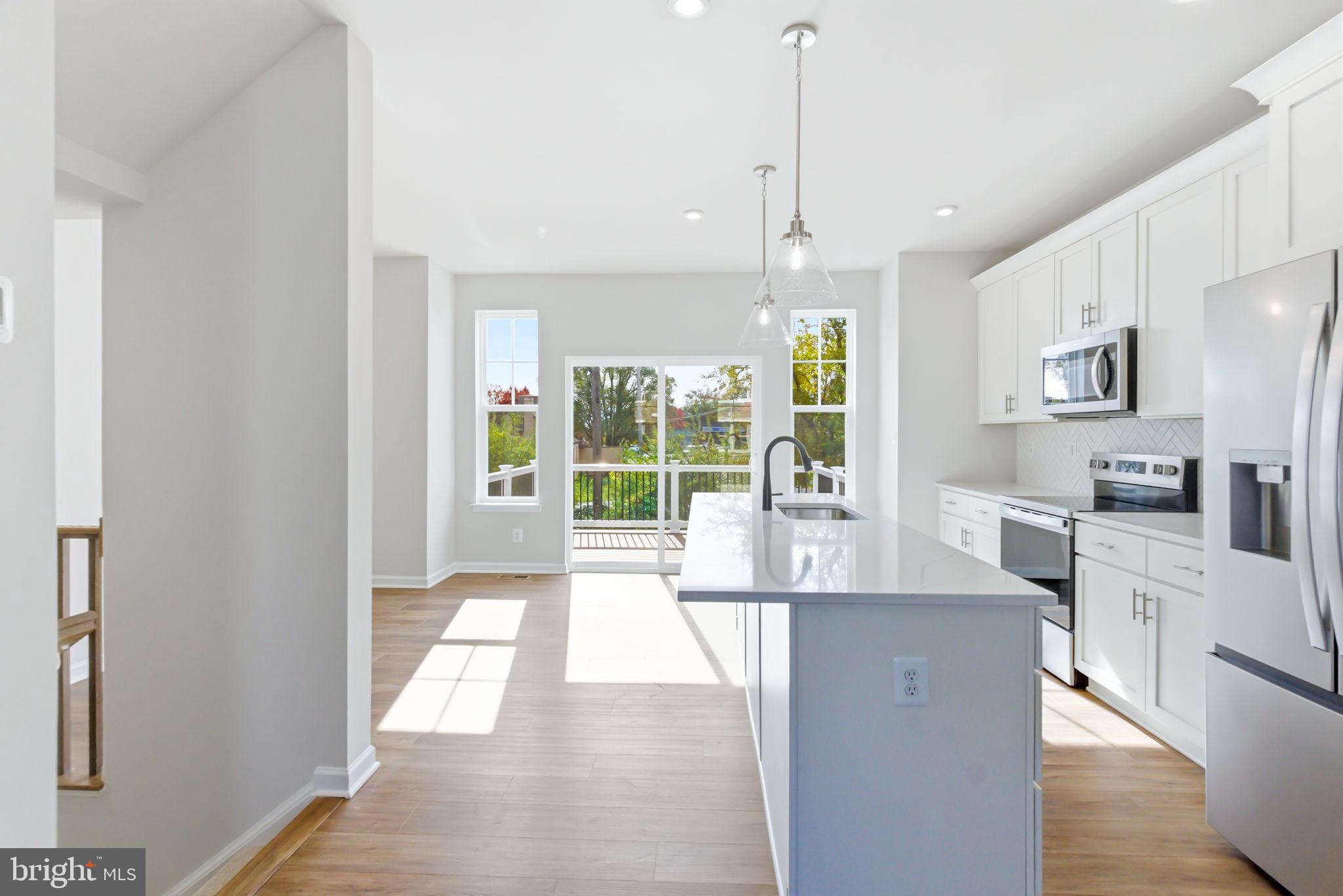 209 Monteith Drive Winchester, VA 22601 - Photo 6 of 29 a large kitchen with sink a refrigerator and a stove top oven