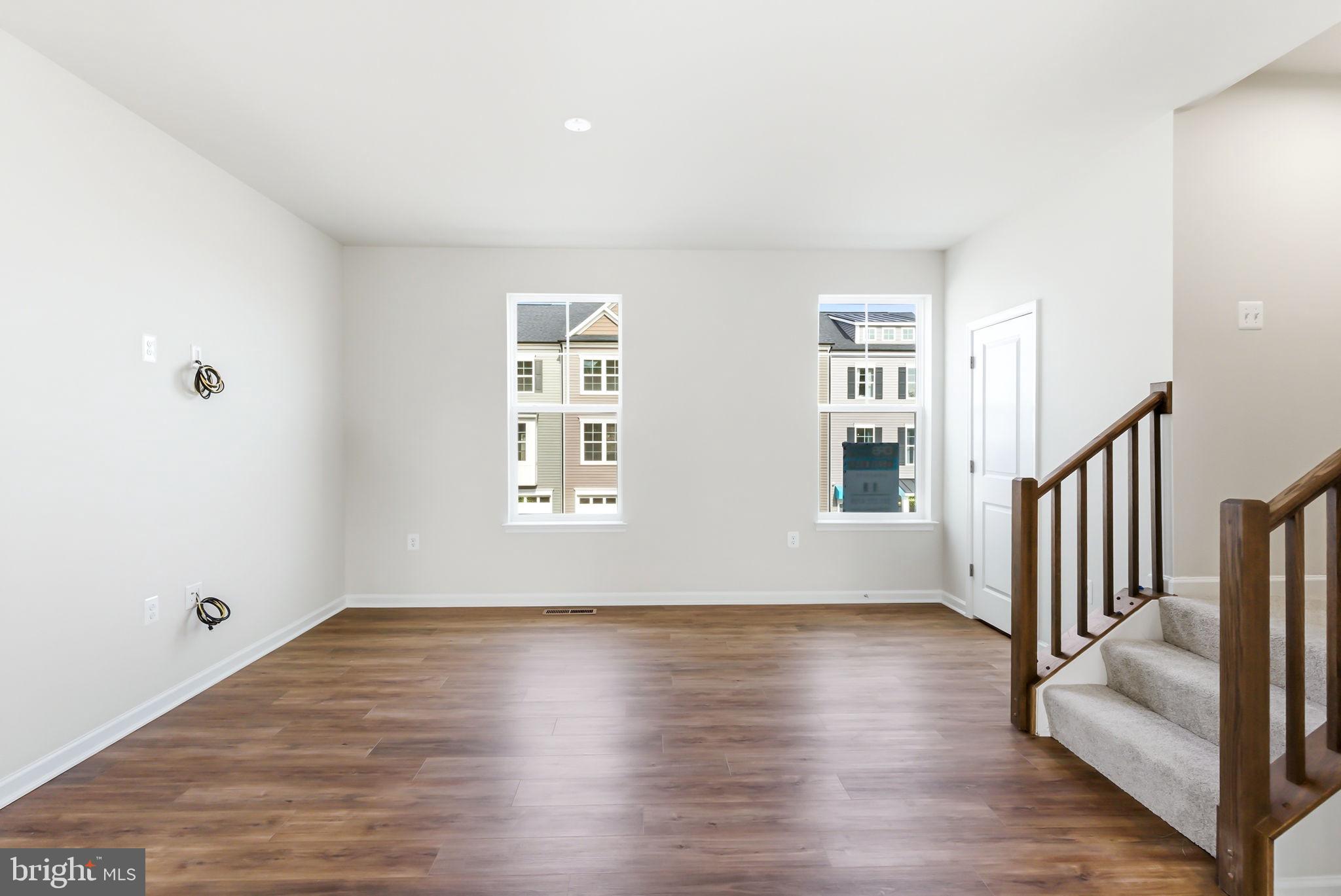 209 Monteith Drive Winchester, VA 22601 - Photo 8 of 29 a view of an empty room with wooden floor and a window