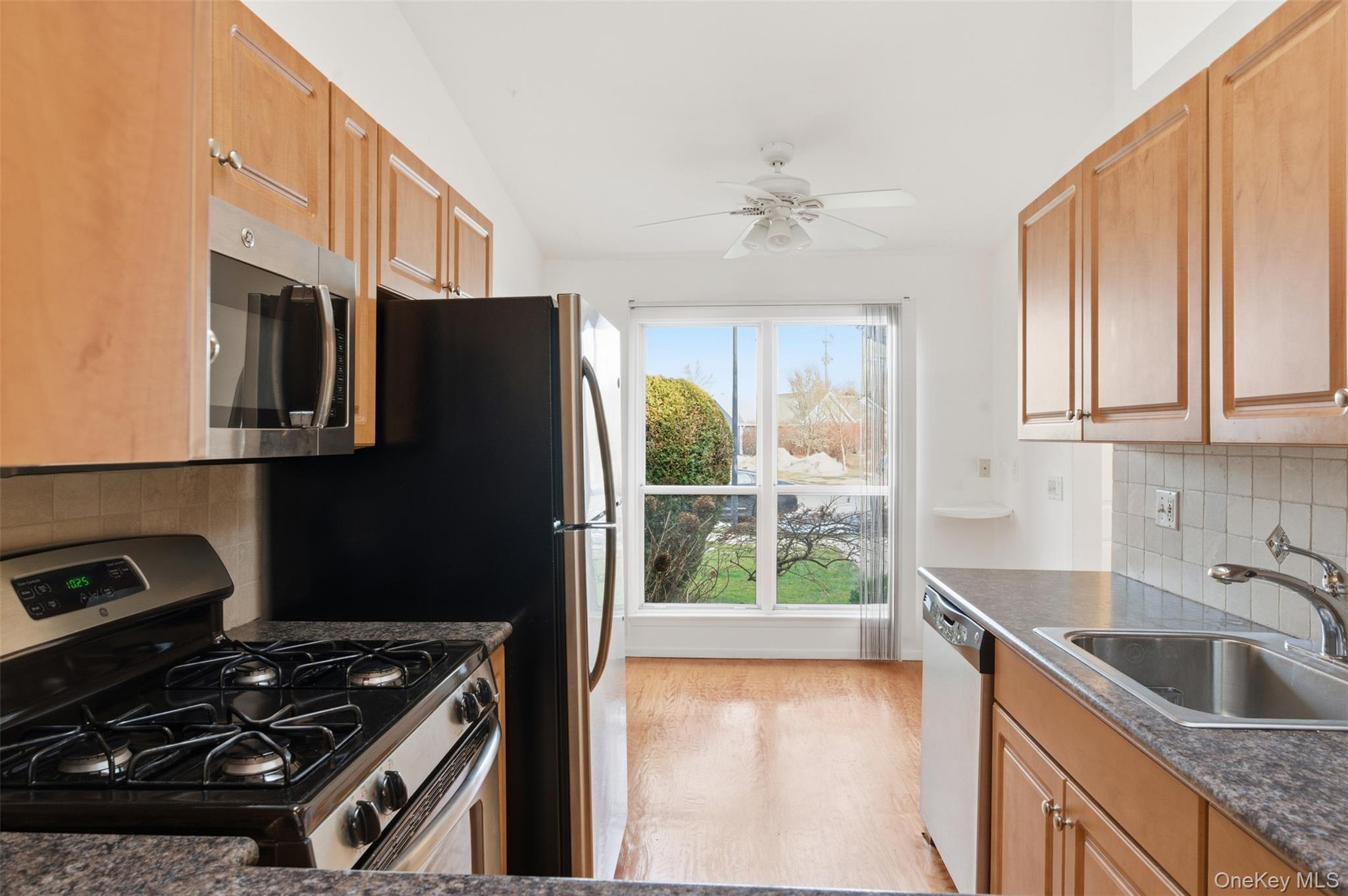 763 Spring Lake Drive Middle Island, NY 11953 - Photo 11 of 31 a kitchen that has a sink a stove and a refrigerator