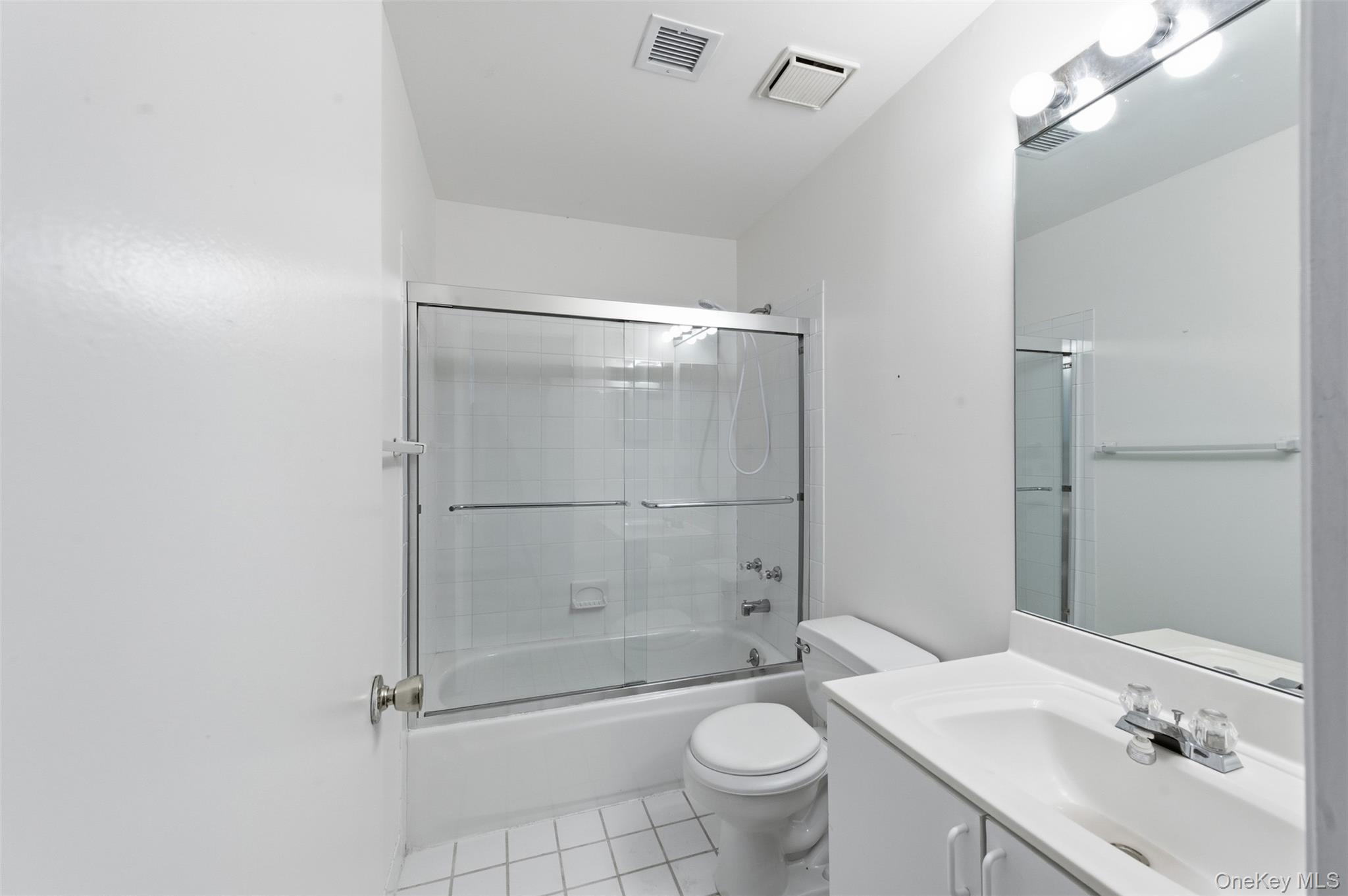 763 Spring Lake Drive Middle Island, NY 11953 - Photo 15 of 31 a bathroom with a sink toilet and shower