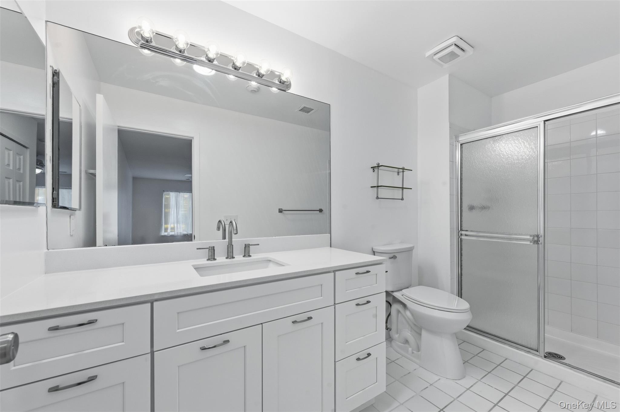 763 Spring Lake Drive Middle Island, NY 11953 - Photo 27 of 31 a bathroom with a toilet a sink and mirror