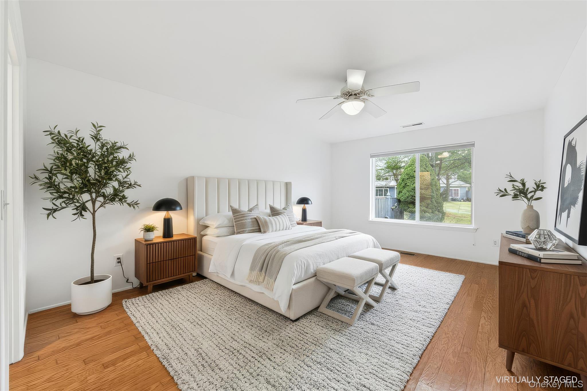 763 Spring Lake Drive Middle Island, NY 11953 - Photo 3 of 31 a bedroom with a large bed and a chandelier