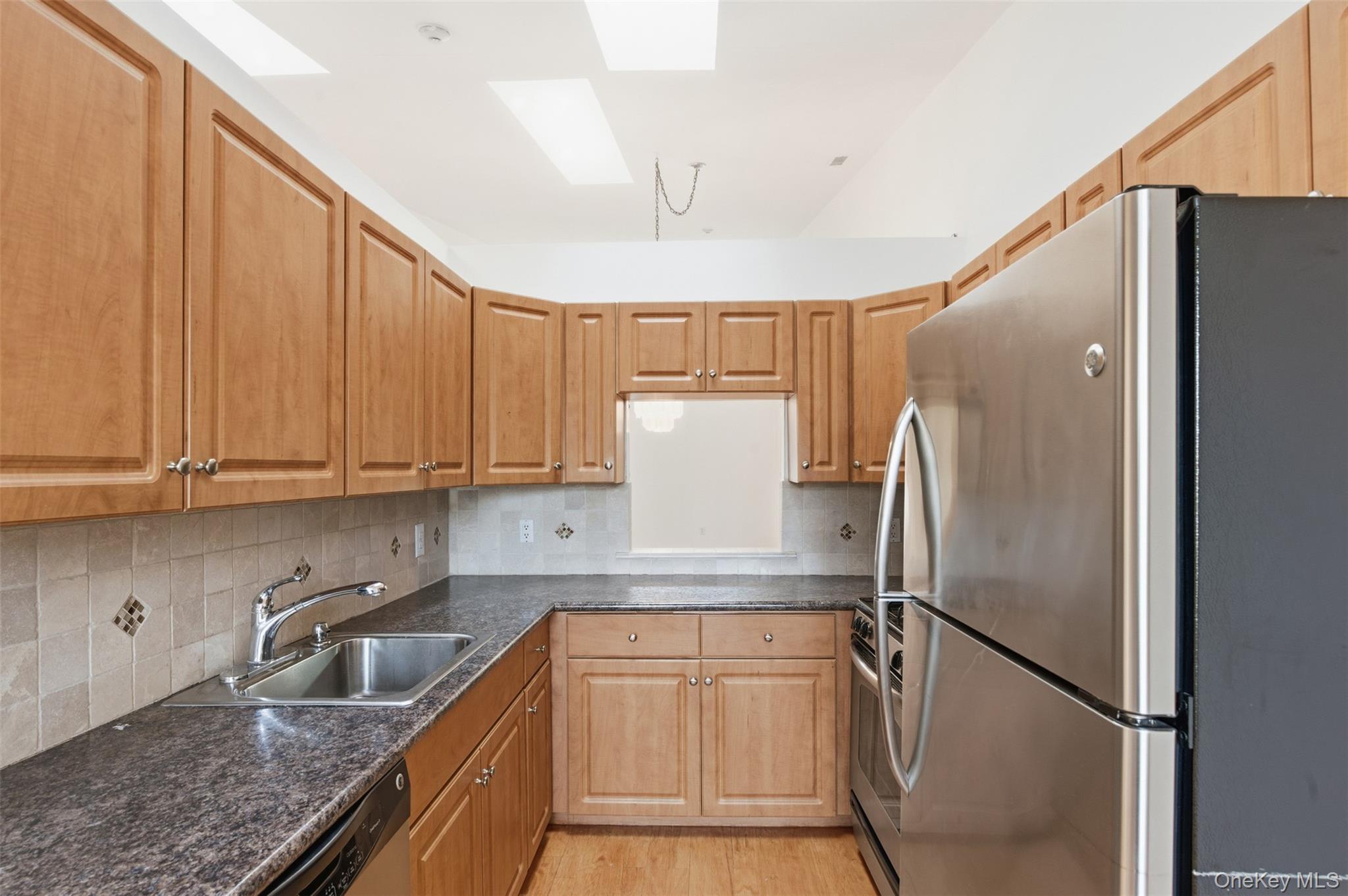 763 Spring Lake Drive Middle Island, NY 11953 - Photo 10 of 31 a kitchen with stainless steel appliances granite countertop a refrigerator and a sink
