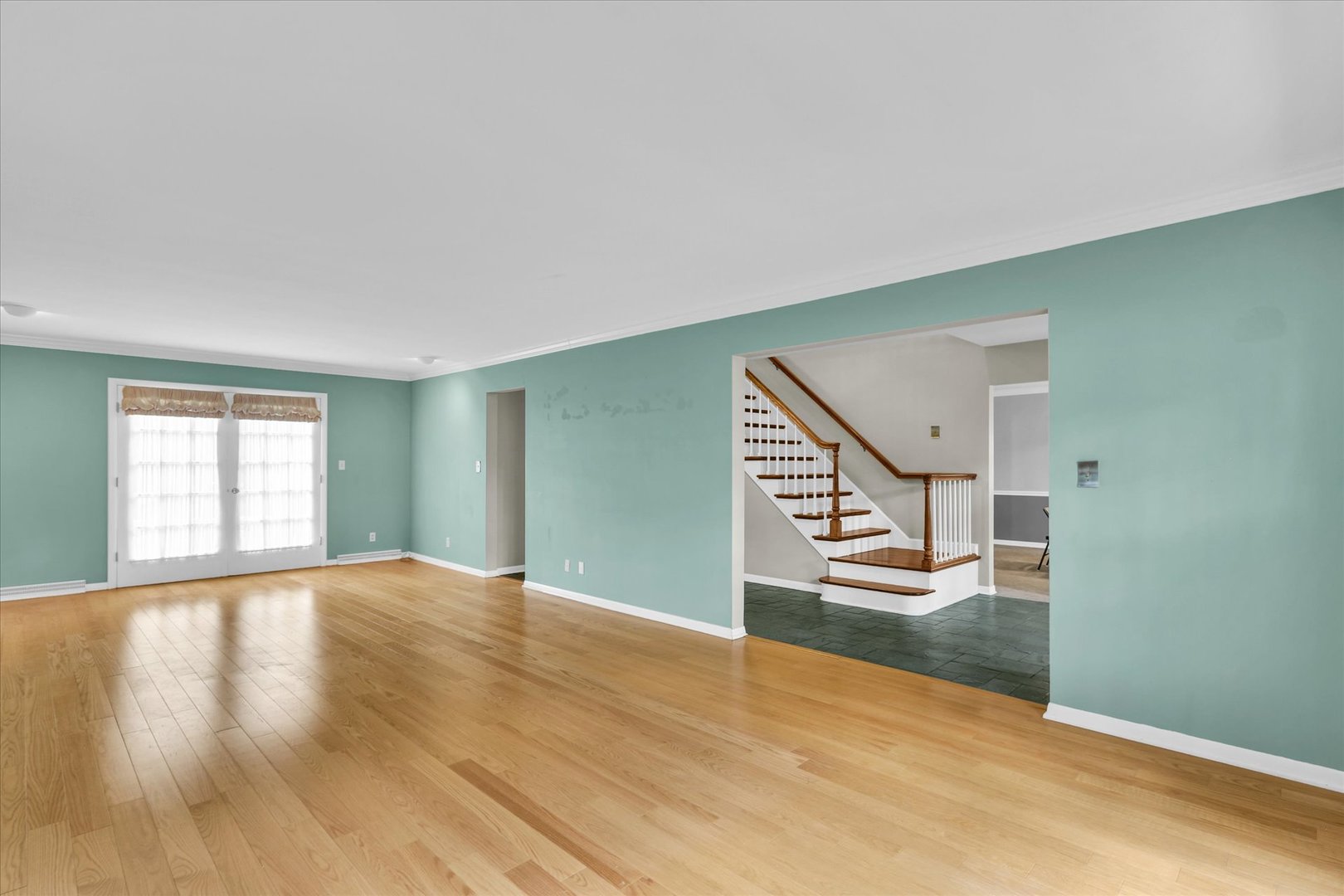 1202 Foothill Drive Champaign, IL 61821 - Photo 8 of 53 a view of empty room with wooden floor and fan