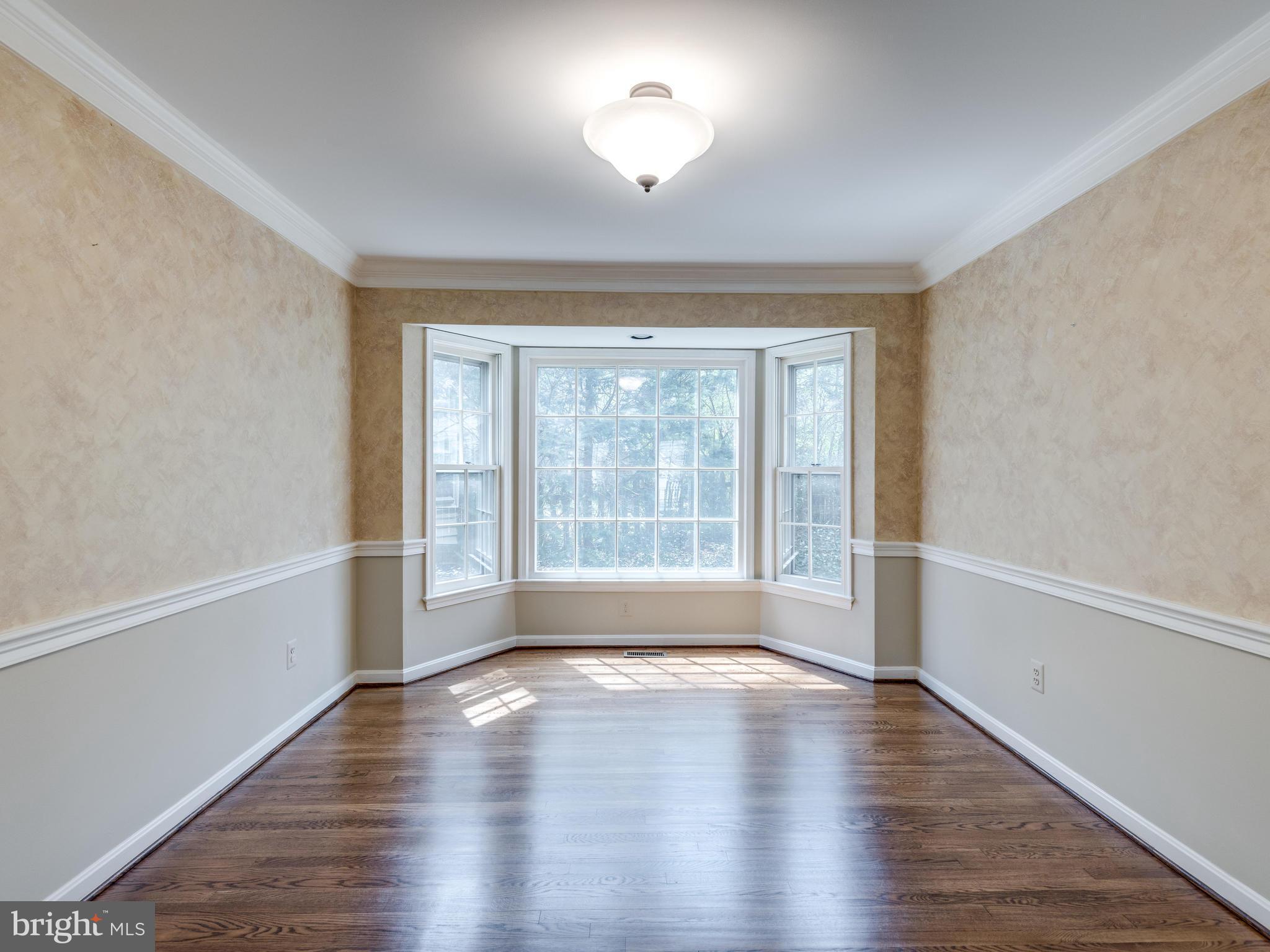 1591 Stowe Road Reston, VA 20194 - Photo 8 of 30 a view of empty room with wooden floor and fan