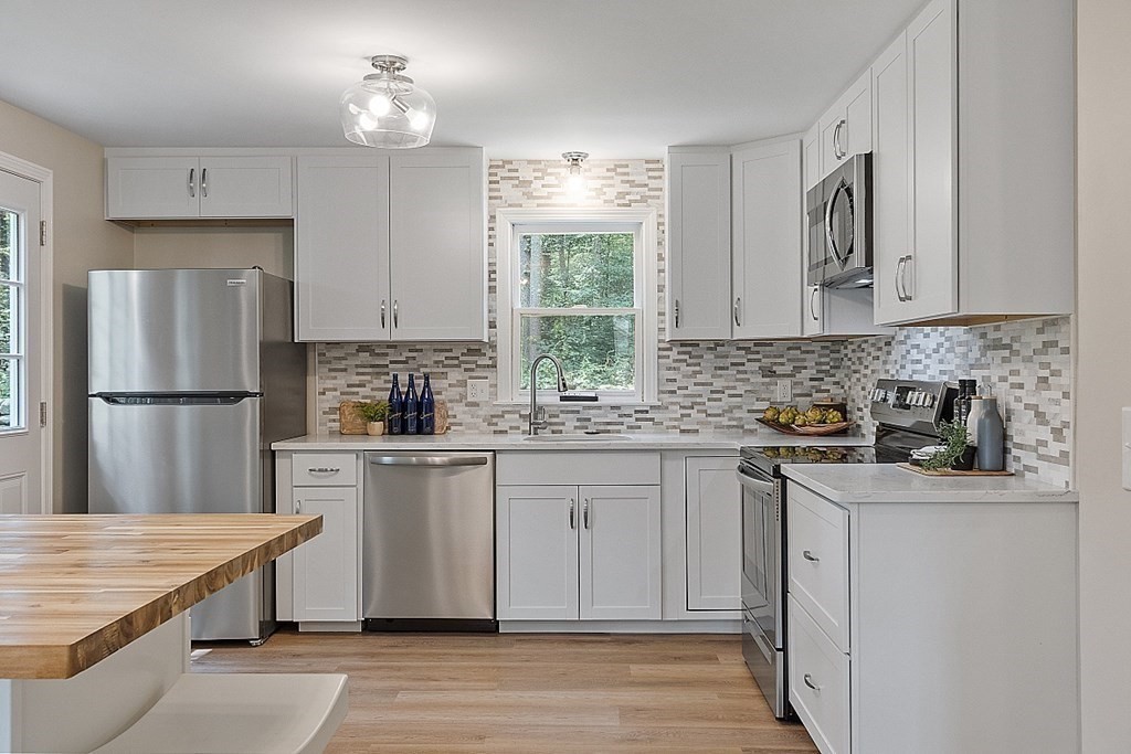 43 R Beaver Brook Road Westford, MA 01886 - Photo 3 of 42 a kitchen with stainless steel appliances granite countertop a refrigerator sink and cabinets