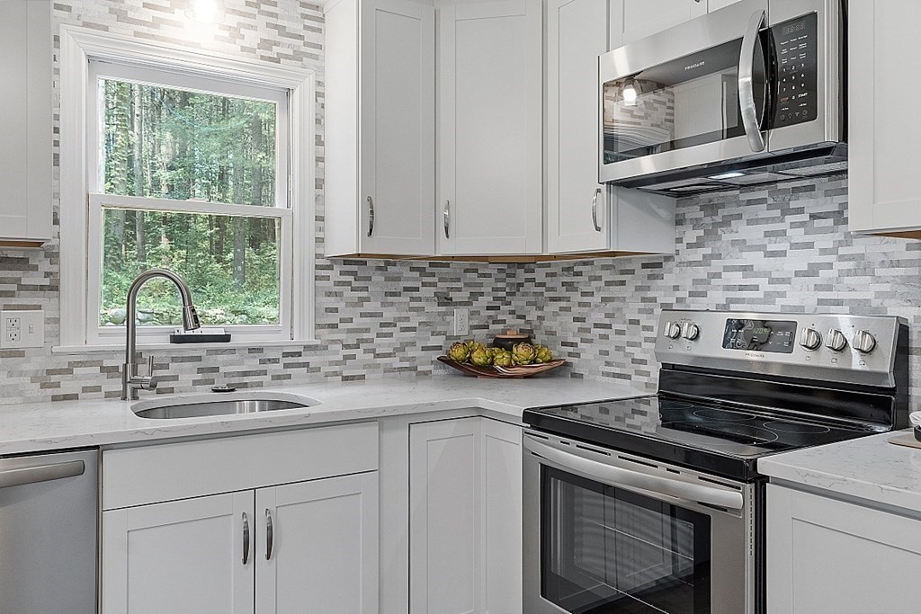 43 R Beaver Brook Road Westford, MA 01886 - Photo 4 of 42 a kitchen with a stove microwave and sink