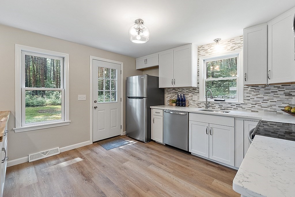 43 R Beaver Brook Road Westford, MA 01886 - Photo 5 of 42 a kitchen with refrigerator cabinets and wooden floor