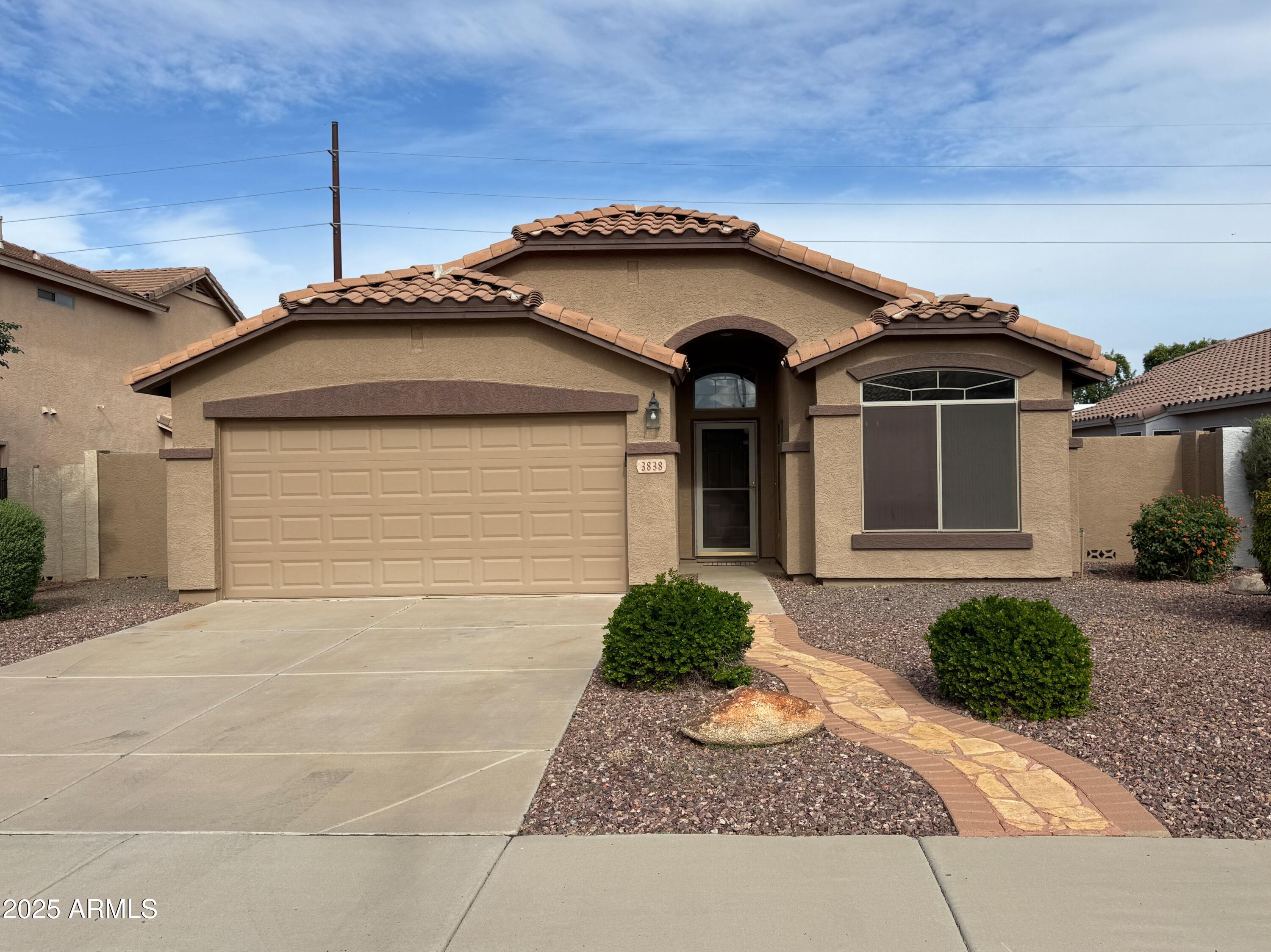 3838 East Derringer Way Gilbert, AZ 85297 - Photo 1 of 24 a front view of a house with garden