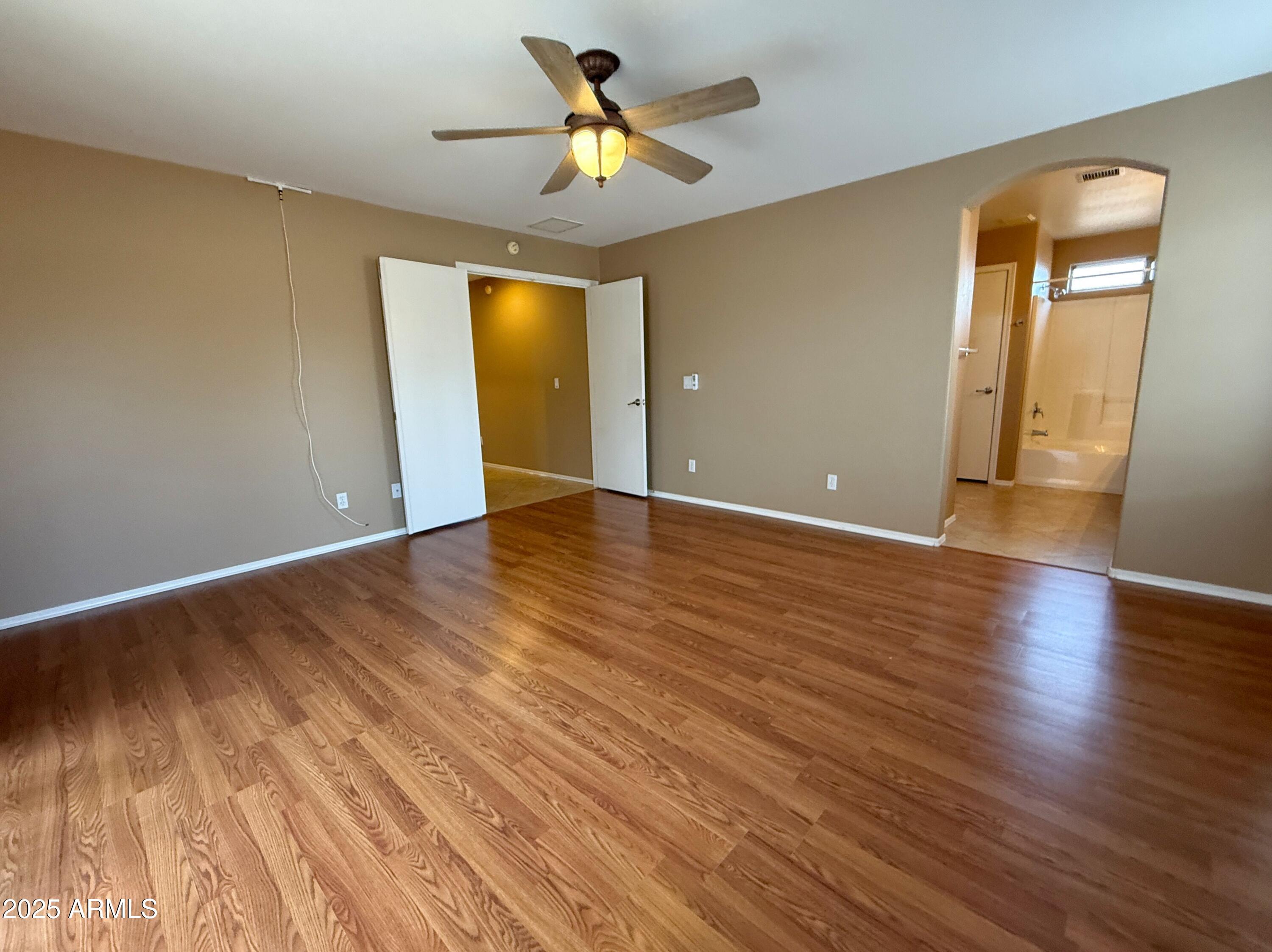 3838 East Derringer Way Gilbert, AZ 85297 - Photo 12 of 24 wooden floor in an empty room with a window