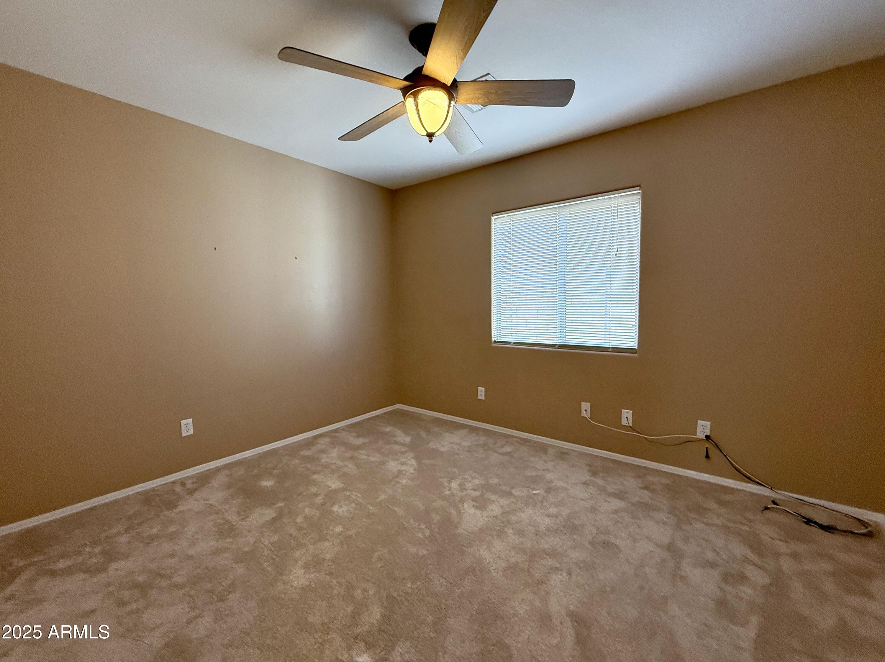 3838 East Derringer Way Gilbert, AZ 85297 - Photo 18 of 24 an empty room and a fan & windows