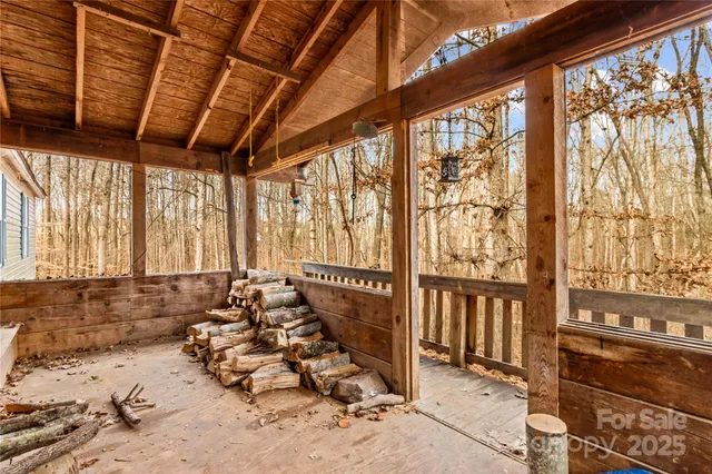 a view of a hallway view with wooden floor and a kitchen space