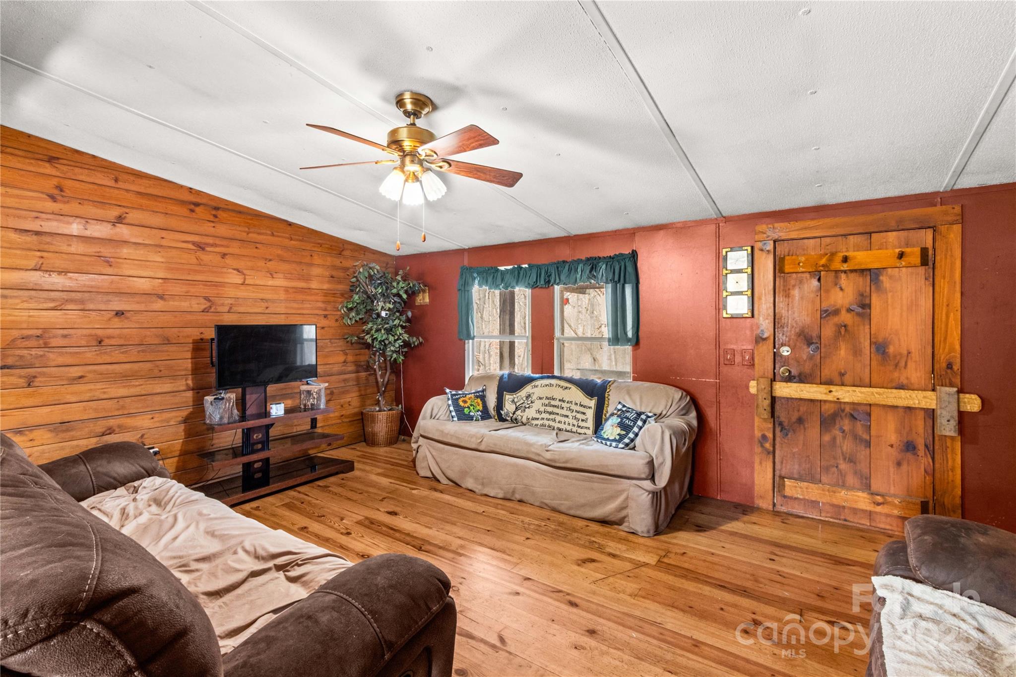 338 Piney Grove Road Harmony, NC 28634 - Photo 14 of 44 a bedroom with a bed a couch and a chandelier