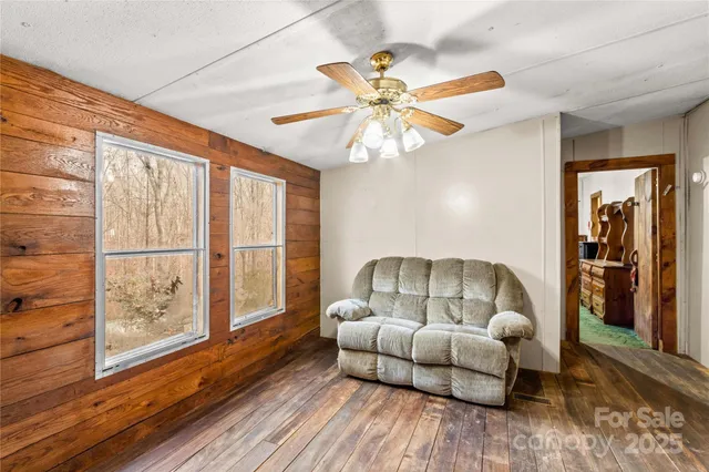 a kitchen with stainless steel appliances granite countertop a stove a sink dishwasher a refrigerator and a dining table with wooden floor