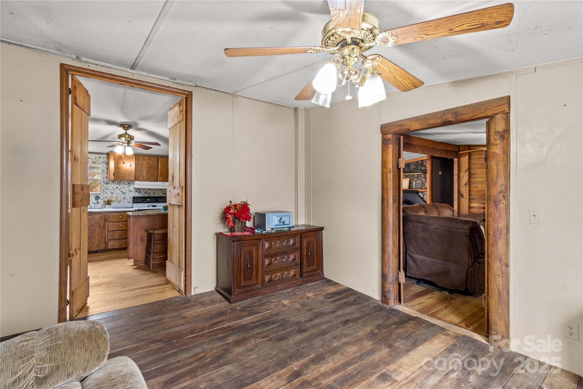 338 Piney Grove Road Harmony, NC 28634 - Photo 18 of 44 a view of a hallway view with wooden floor and a kitchen space