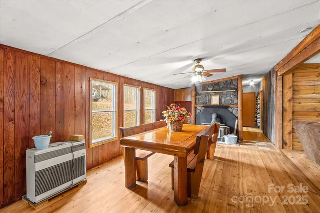 a kitchen with a table chairs and wooden floor