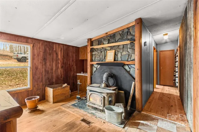 a kitchen with a stove a sink a dining table and chairs
