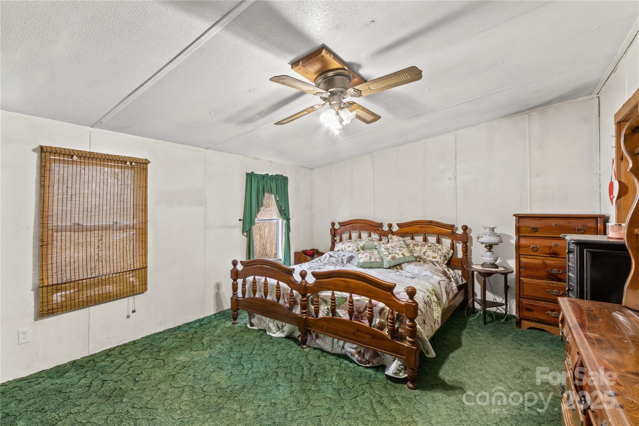 338 Piney Grove Road Harmony, NC 28634 - Photo 33 of 44 a bedroom with a bed and a chandelier
