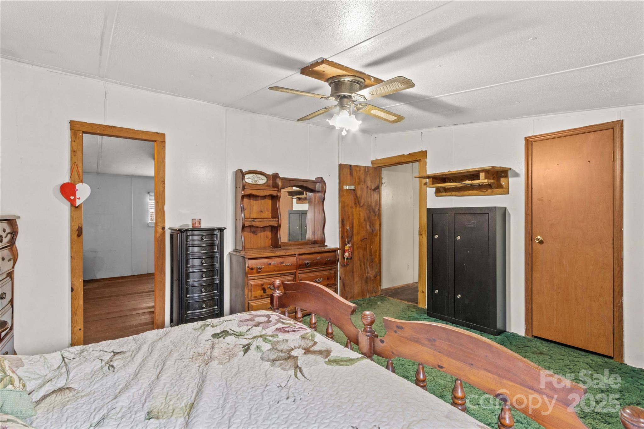 338 Piney Grove Road Harmony, NC 28634 - Photo 34 of 44 a bedroom with a bed and a chandelier