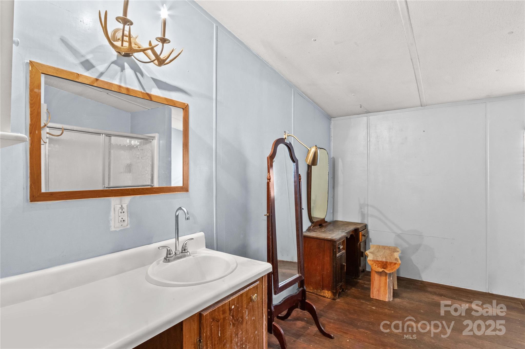 338 Piney Grove Road Harmony, NC 28634 - Photo 35 of 44 a bathroom with a sink a mirror and a toilet