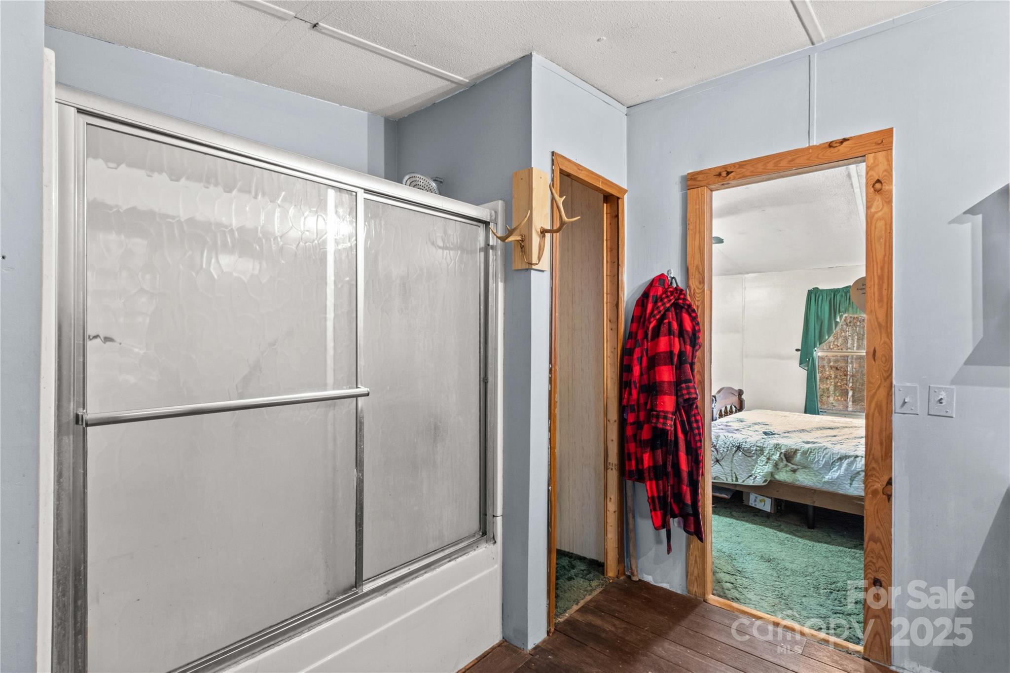 338 Piney Grove Road Harmony, NC 28634 - Photo 36 of 44 a view of walk in closet with clothes and shoes
